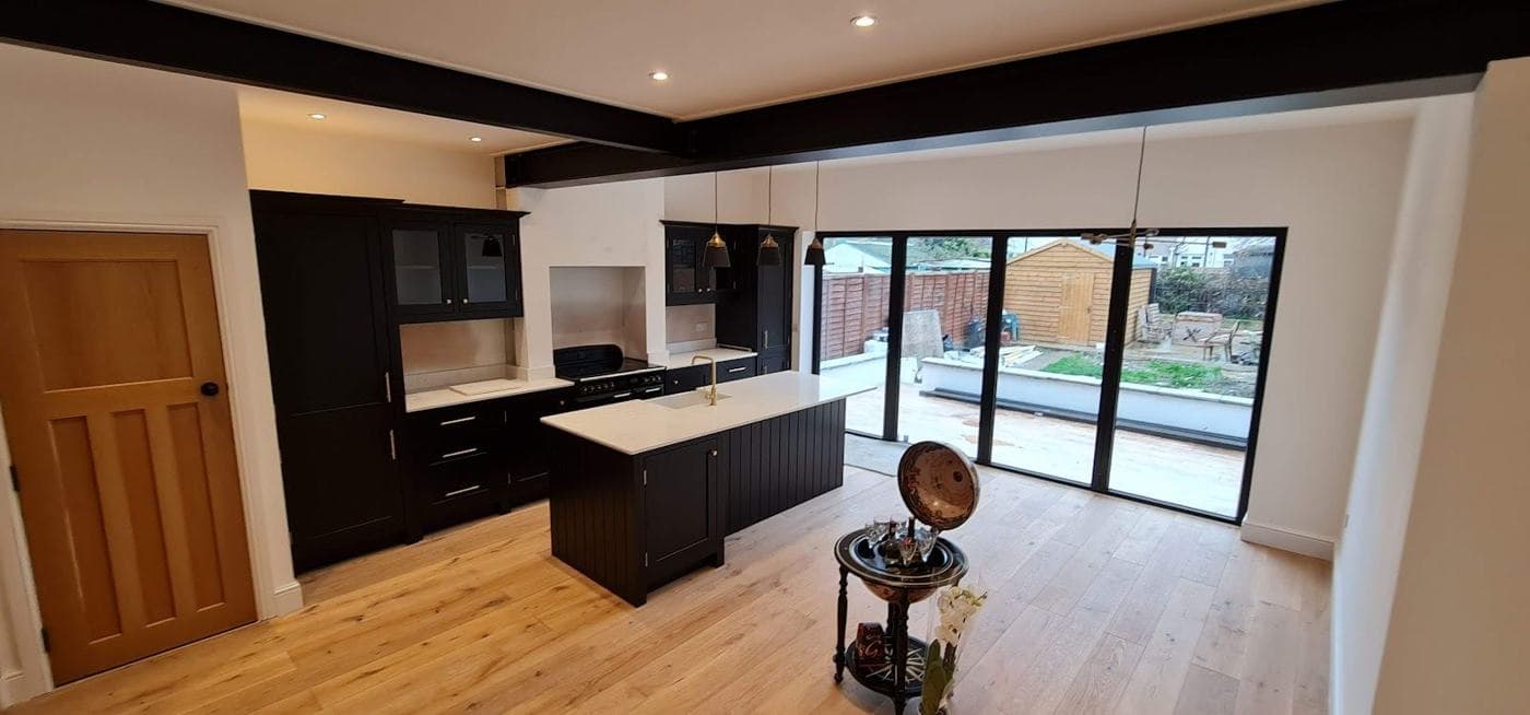 Open-plan kitchen extension with island, oak floor and full-width glazing — rcbGroup project