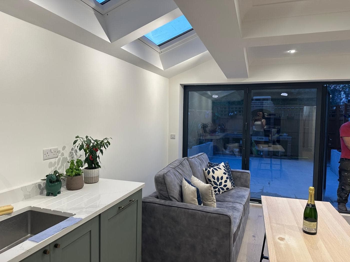 Side extension kitchen with rooflights, sage green units and bi-fold doors — rcbGroup project